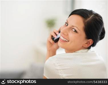 Portrait of happy young woman speaking cellphone