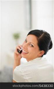 Portrait of happy young woman speaking mobile phone
