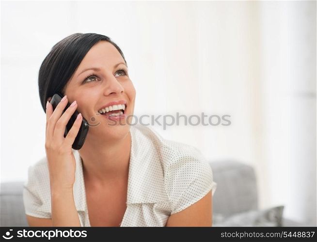 Portrait of happy young woman talking mobile phone
