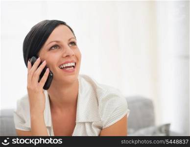 Portrait of happy young woman talking mobile phone
