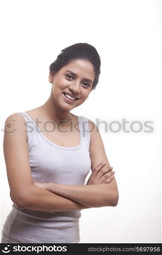 Portrait of happy young woman with arms crossed isolated over white background