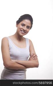 Portrait of happy young woman with arms crossed isolated over white background