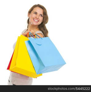 Portrait of happy young woman with shopping bags looking on copy space