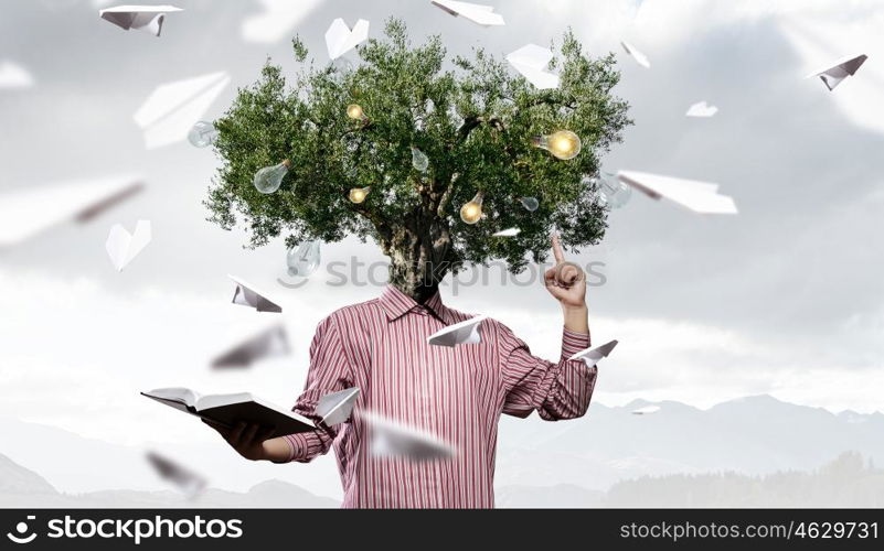 Portrait of headless guy. Man with book in hand and tree instead of head