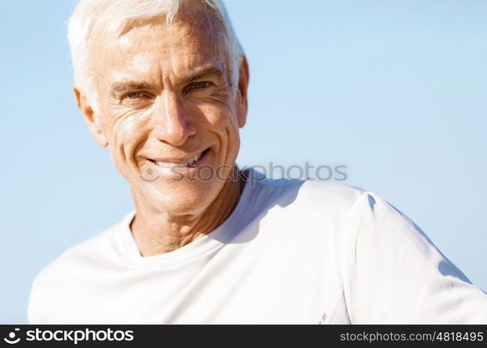 Portrait of healthy senior man. Portrait of healthy senior man smiling at camera