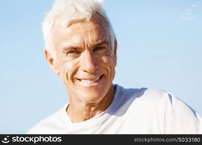 Portrait of healthy senior man. Portrait of healthy senior man smiling at camera