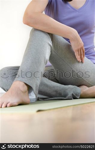 Portrait of healthy young lady practicing yoga exercise - Spine twisting pose