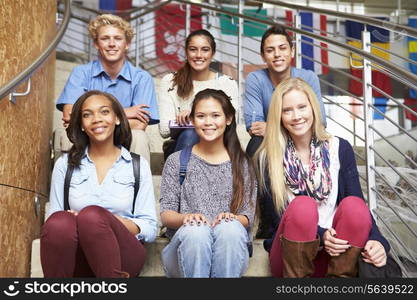 Portrait Of High School Students Sitting Outside Building