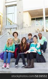 Portrait Of High School Students Sitting Outside Building