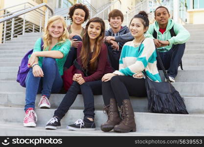 Portrait Of High School Students Sitting Outside Building