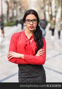 Portrait of hispanic businesswoman in urban background