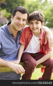 Portrait Of Hispanic Father And Son In Countryside
