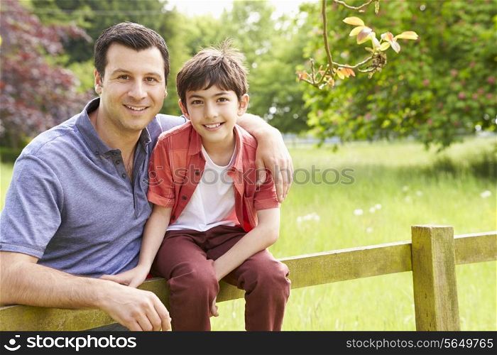 Portrait Of Hispanic Father And Son In Countryside