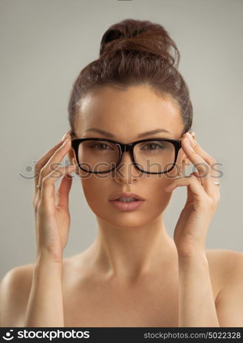 Portrait of hot sexy naked woman wearing glasses