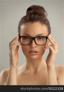 Portrait of hot sexy naked woman wearing glasses