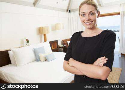 Portrait Of Hotel Chambermaid In Guest Room
