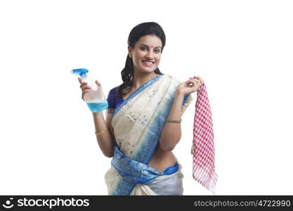 Portrait of housewife with spray bottle and cloth