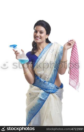 Portrait of housewife with spray bottle and cloth
