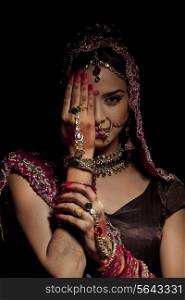 Portrait of Indian bride hiding half her face