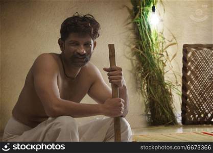 Portrait of Indian farmer holding hoe