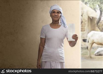 Portrait of Indian farmer showing a bank cheque