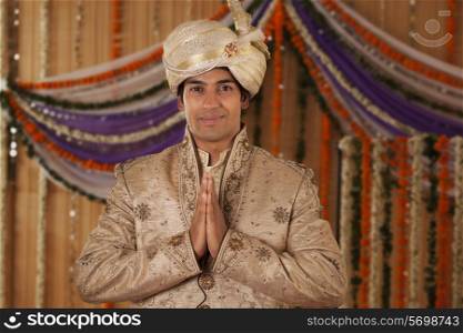 Portrait of Indian groom greeting