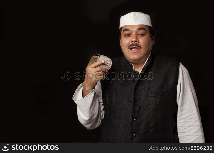 Portrait of Indian politician holding paper currency