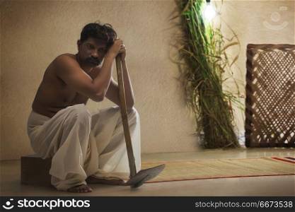 Portrait of Indian rural farmer holding hoe
