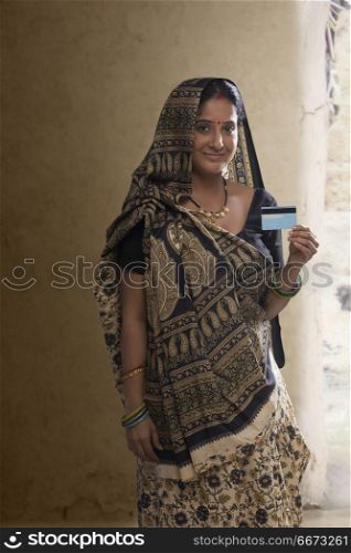 Portrait of Indian rural woman holding credit card