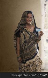Portrait of Indian rural woman holding credit card