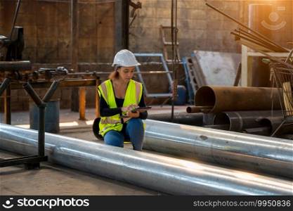 Portrait of industrial woman engineer working in a factory.