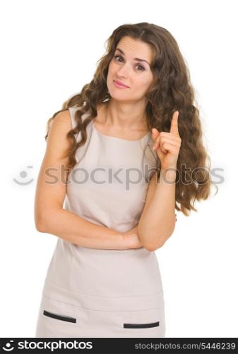 Portrait of interested young woman pointing on fact