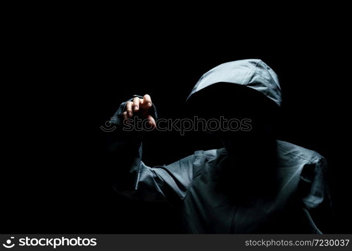 Portrait of Invisible man in the hood on black background.