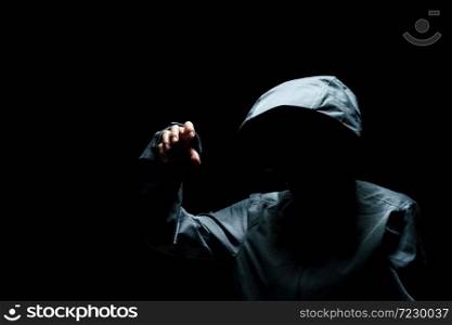 Portrait of Invisible man in the hood on black background.
