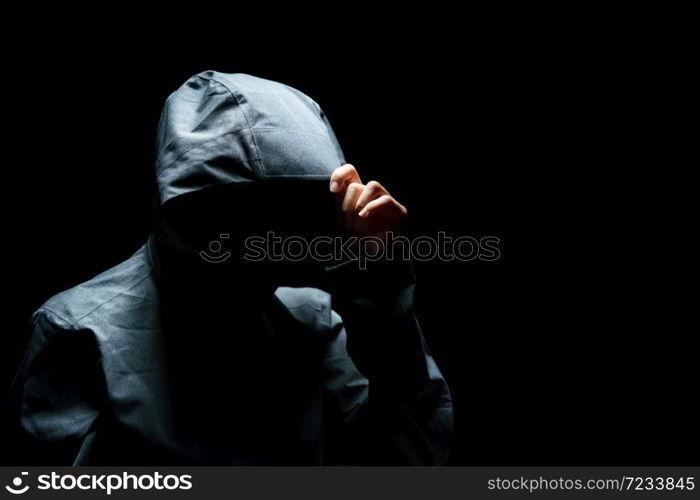 Portrait of Invisible man in the hood on black background.