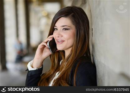 Portrait of japanese business woman in urban background on the phone