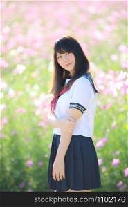 Portrait of Japanese school girl uniform smile with cosmos flower