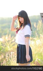 Portrait of Japanese school girl uniform smile with cosmos flower