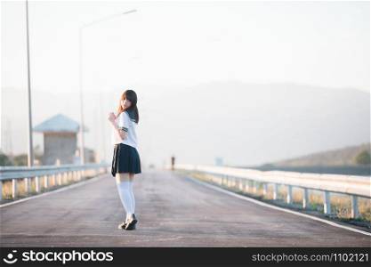 Portrait of Japanese school girl uniform smile with walkway and river