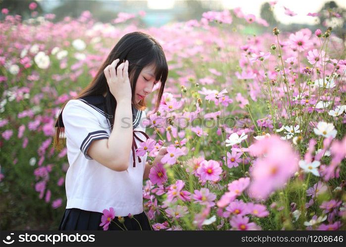 Portrait of Japanese school girl uniform with pink cosmos flower