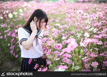 Portrait of Japanese school girl uniform with pink cosmos flower