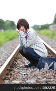 Portrait of Japanese school girl with countryside park