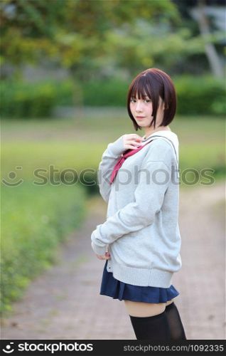 Portrait of Japanese school girl with countryside park