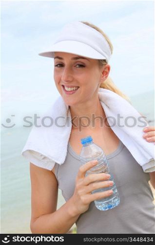 Portrait of jogger drinking water