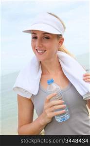 Portrait of jogger drinking water