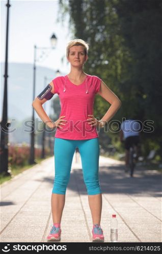 portrait of jogging woman before running on early morning with sunrise in background