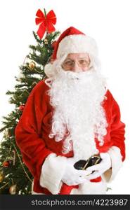 Portrait of jolly Santa Claus in front of a Christmas tree. White background.