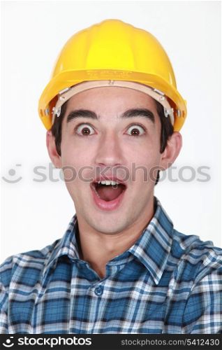 portrait of junior tradesman open-mouthed in surprise