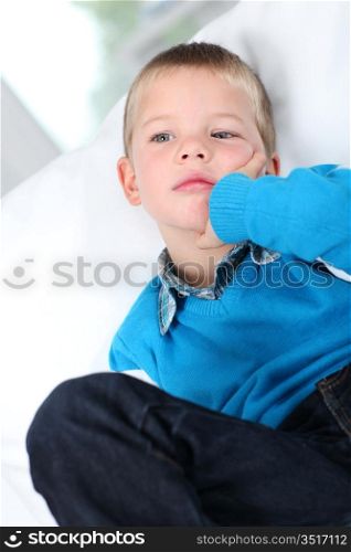 Portrait of kid sitting in sofa