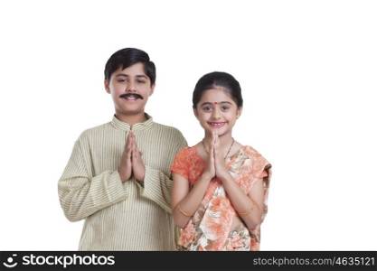 Portrait of kids dressed as husband and wife greeting